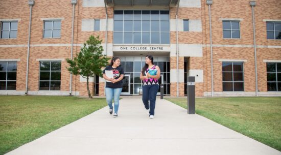 Students with books walking in front of Temple College