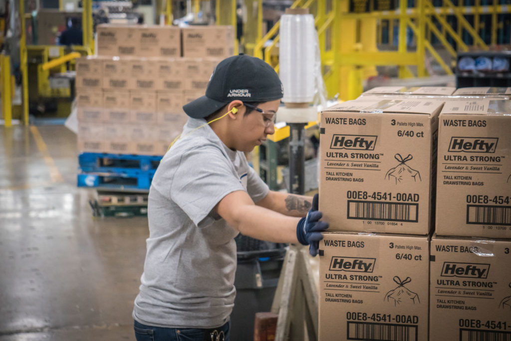 A Reynolds employee moves boxes in a warehouse facility in Temple, TX